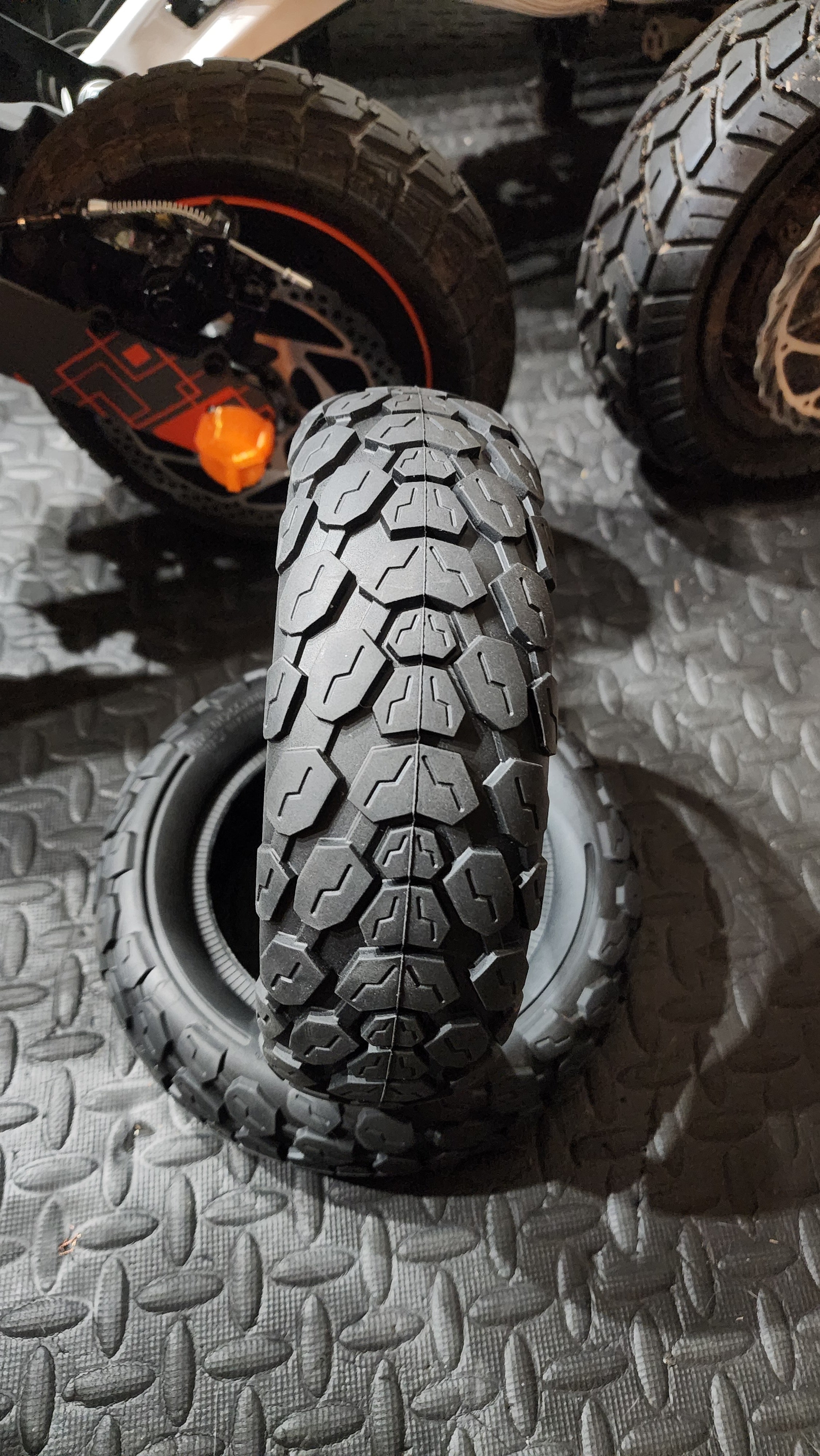 closeup of 2 solid electric scooter tires with hybrid tread design