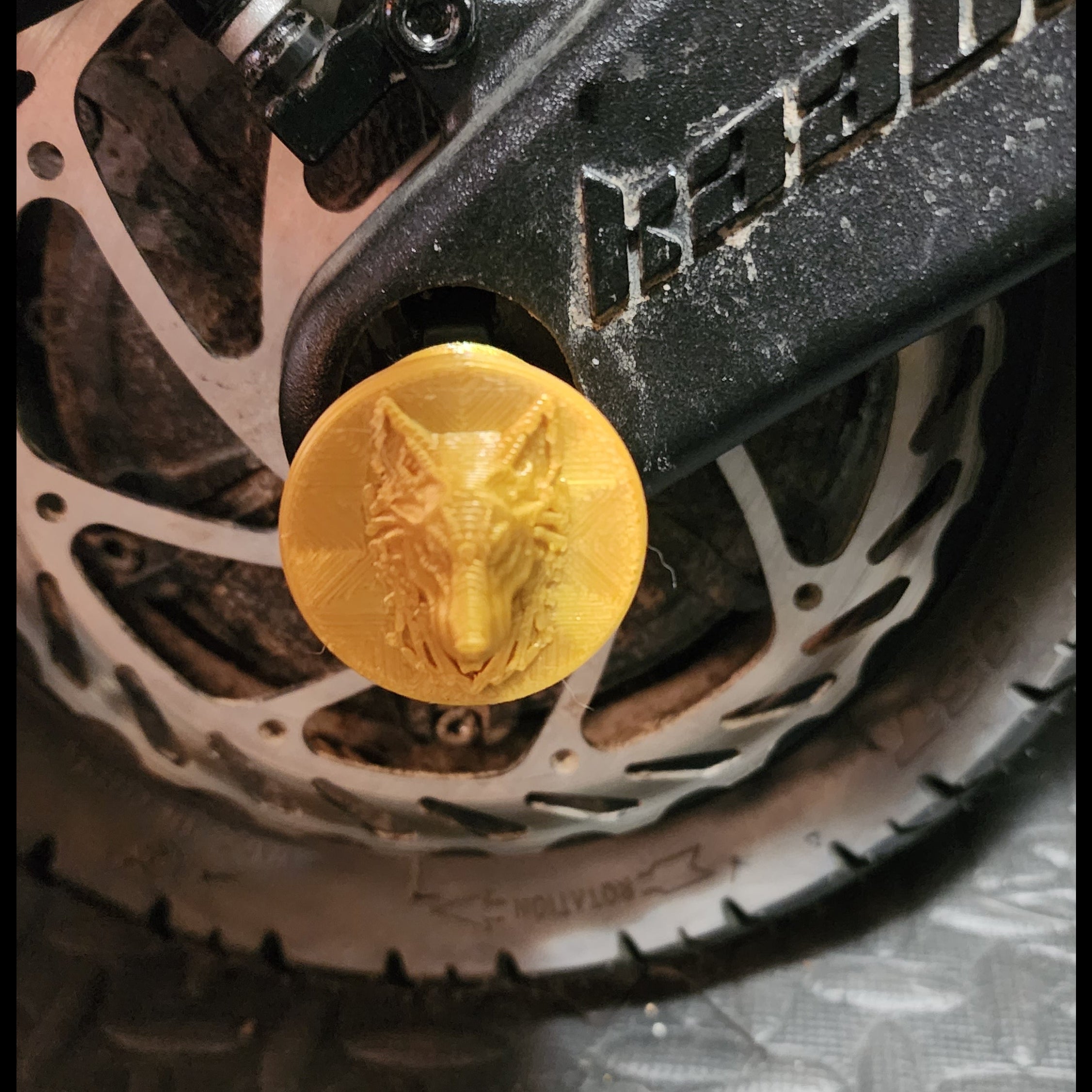 A Gold colored 3d printed Lugg Nutt cover used on any Kaabo scooters with 21mm bolts. 